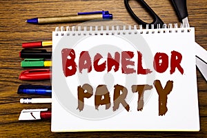 Word, writing Bachelor Party. Business concept for Stag Fun Celebrate Written on notebook, wooden background with office equipment photo