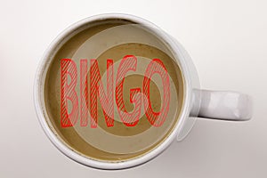 Word, writing Bingo text in coffee in cup. Business concept for Lettering Gambling to Win Price Success on white background with c