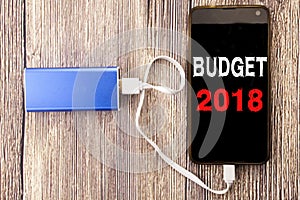 Word, writing Budget 2018. Business concept for Household budgeting accounting planning written on mobile cell phone mobile and po