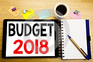 Word, writing Budget 2018. Business concept for Household budgeting accounting planning Written on tablet laptop, wooden backgroun