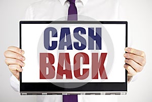 Word, writing Cash Back Cashback. Business concept for Money Assurance Written on tablet laptop holding by the man blurred backgro