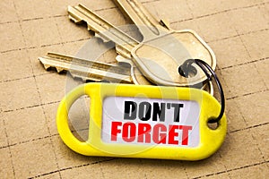 Word, writing Do Not Forget. Business concept for Don t memory Remider Written on key holder, textured background close up. photo