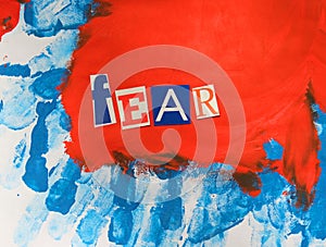 Word writing Fear from cut letters on abstract strokes blue red background. Headline - Fear, card of psychology . Psychologic
