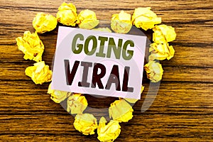 Word, writing Going Viral. Business concept for Social Viral Business written on sticky note paper on the wooden background.