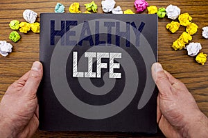 Word, writing Healthy Life. Business concept for Good Health Food written on notepad notebook book on the wooden wood background w