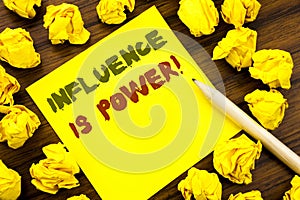 Word, writing Influence Is Power. Business concept for Persuasion Strategy Written on sticky note paper, wooden background with fo photo