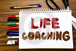 Word, writing Life Coaching. Business concept for Personal Coach Help Written on notebook, wooden background with office equipment