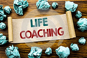 Word, writing Life Coaching. Business concept for Personal Coach Help Written on sticky note paper, wooden background with folded