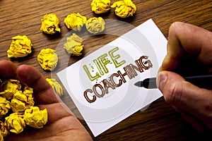 Word, writing Life Coaching. Concept for Personal Coach Help written on notebook note paper on the wooden background with folded p