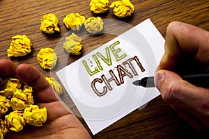 Word, writing Live Chat . Concept for Communication Livechat written on notebook note paper on the wooden background with folded p photo
