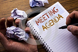 Word, writing Meeting Agenda. Concept for Business Schedule Plan written on notebook notepad note paper on the wooden background w