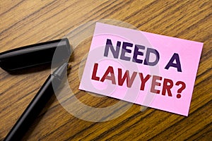 Word, writing Need A Lawyer. Business concept for Advocacy Justice Help Written on sticky note red paper, wooden background with p