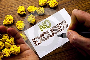 Word, writing No Excuses. Concept for Stop Ban for Excuse written on notebook note paper on the wooden background with folded pape