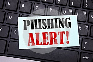 Word, writing Phishing Alert. Business concept for Fraud Warning Danger written on sticky note paper on the black keyboard backgro
