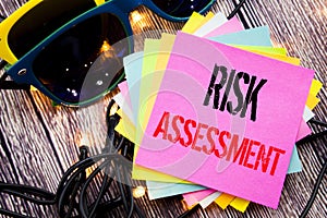 Word, writing Risk Assessment. Business concept for Safety Danger Analyze written on sticky note with copy space on old wood woode