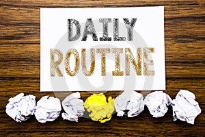 Word, writing Daily Routine. Concept for Habitual Lifestyle Written on sticky note paper reminder, wooden background with sticky,