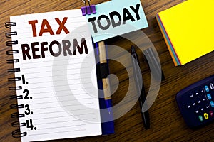 Word, writing Tax Reform. Business concept for Government Change in Taxes written on book note paper on the wooden background. Wit