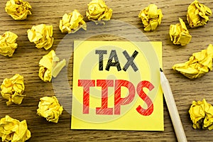 Word, writing Tax Tips. Business concept for Taxpayer Assistance Refund Reimbursement written on sticky note paper on the wooden b