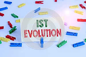 Word writing text 1St Evolution. Business concept for Change in the genetic features of biological populations Colored clothespin