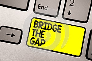 Word writing text Bridge The Gap. Business concept for Overcome the obstacles Challenge Courage Empowerment Keyboard yellow key In