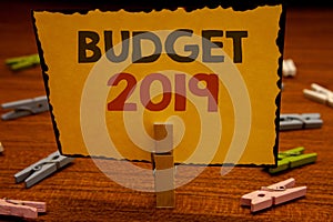 Word writing text Budget 2019. Business concept for New year estimate of incomes and expenses Financial PlanClothespin hold holdin