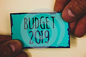 Word writing text Budget 2019. Business concept for New year estimate of incomes and expenses Financial PlanMan hold holding turqu