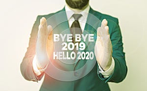 Word writing text Bye Bye 2019 Hello 2020. Business concept for saying goodbye to last year and welcoming another good one Man