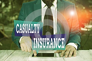 Word writing text Casualty Insurance. Business concept for overage against loss of property or other liabilities Businessman in photo