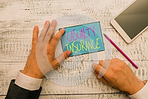 Word writing text Casualty Insurance. Business concept for overage against loss of property or other liabilities Hand photo