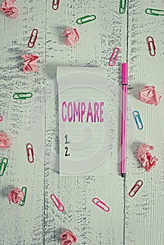 Word writing text Compare. Business concept for Estimate Measure Note the similarities dissimilarities between Stripped notepad photo