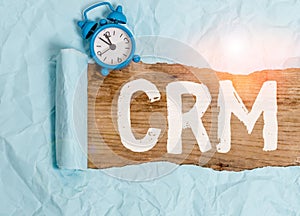 Word writing text Crm. Business concept for Strategy for analysisaging the Affiliation Interactions of an organization Alarm clock