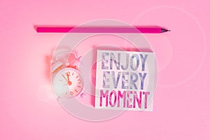 Word writing text Enjoy Every Moment. Business concept for being pleased with your life Have fun Precious time Metal vintage alarm