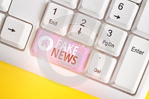 Word writing text Fake News. Business concept for Giving information to showing that is not true by the media White pc photo