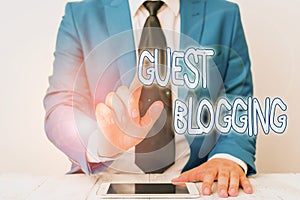 Word writing text Guest Blogging. Business concept for used by the owners of blogs to increase traffic to their site Businessman