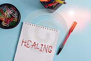 Word writing text Healing. Business concept for process of making or becoming sound or healthy again Helping injured Notebook and