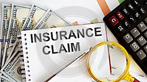 Word writing text INSURANCE CLAIM . Business concept with chart, dollars and office tools