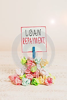 Word writing text Loan Repayment. Business concept for act of paying back money previously borrowed from a lender Reminder pile