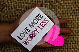 Word writing text Love More Worry Less. Business concept for Have a good attitude motivation be lovable enjoy life Human hand touc