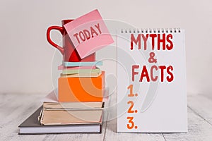 Word writing text Myths And Facts. Business concept for usually traditional story of ostensibly historical events Cup photo