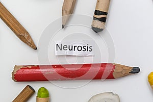 A word writing text neurosis among pencils, writing a diary and describing psycholigical problem, art therapy concept