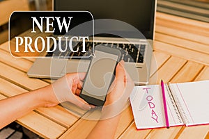 Word writing text New Product. Business concept for goods and services that differ in their characteristics woman laptop