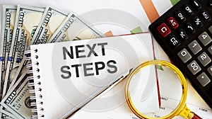 Word writing text NEXT STEPS . Business concept with chart, dollars and office tools