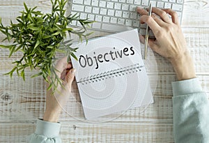 Word writing text OBJECTIVES . Business concept on the notebook