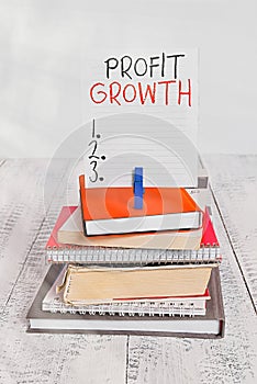 Word writing text Profit Growth. Business concept for Objectives Interrelation of Overall Sales Market Shares pile stacked books