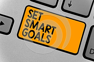 Word writing text Set Smart Goals. Business concept for Establish achievable objectives Make good business plans Keyboard orange k