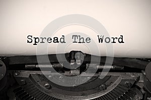 Word writing text Spread The Word on a vintage typewriter