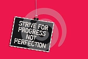 Word writing text Strive For Progress Not Perfection. Business concept for Improve with flexibility Advance Grow Hanging blackboar