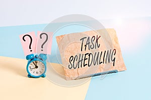 Word writing text Task Scheduling. Business concept for The assignment of start and end times to a set of tasks Mini size alarm