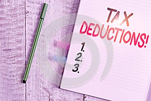 Word writing text Tax Deductions. Business concept for reduction income that is able to be taxed of expenses Thick pages