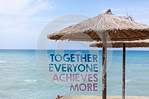 Word writing text Together Everyone Achieves More. Business concept for Teamwork Cooperation Attain Acquire Success Blue beach wat